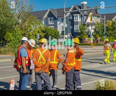 Road worker construction. Road workers inspecting construction. Engineer worker tablet working on site road construction. Men architecture builder bui Stock Photo