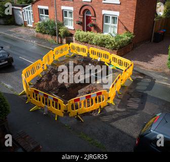 Road closure and excavation to repair water pipes in the Uk. Stock Photo