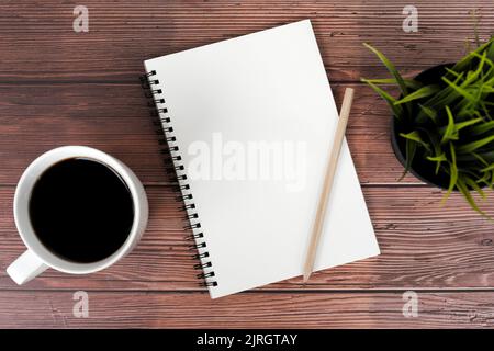 Black coffee and blank note pad with pencil flat lay Stock Photo
