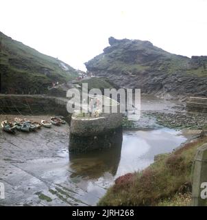 1971, historical, view of the habour at Boscastle, Cornwall, England, UK, with the tide out. A scenic spot on the north coast of Cornwall, the tiny harbour was orginally built to handle trade in slate from the nearby Delabole quarries and before the railways was a thriving port. Stock Photo