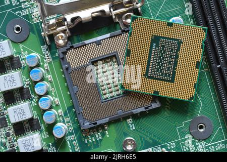 Detail of a CPU Processor over his Socket on a Motherboard. Printed ...