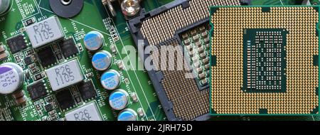 Detail of CPU Chip over socket of a modern computer motherboard. Electronic small component details. long banner web image Stock Photo