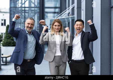 Success Happy Group business people excited rejoicing looking at camera after successful completion project, and smiling Portrait diverse team employees celebrating victory. Stock Photo
