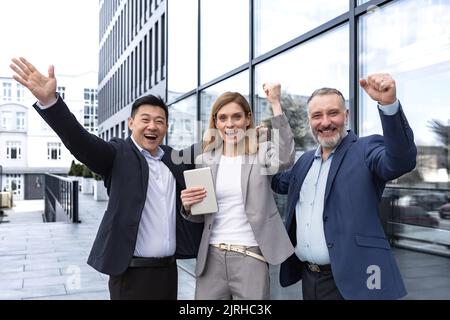 Success Happy Group business people excited rejoicing looking at camera after successful completion project, and smiling Portrait diverse team employees celebrating victory. Stock Photo