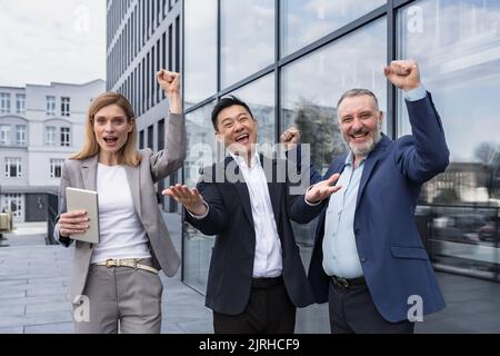 Success Happy Group business people excited rejoicing looking at camera after successful completion project, and smiling Portrait diverse team employees celebrating victory. Stock Photo