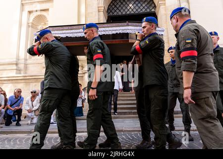 The coffin is assisted out of the church as crowds attend a funeral of a serviceman, killed by the Russian army in Saint Peter and Paul Cathedral in the old town of Lviv on August 24. Senior Lieutenant Mykhailo Gamkalo, was also associate professor of the Department of Tourism of Lviv University. The city of Lviv selected a separate slot of land in the cemetery for the soldiers fallen in the fight with Russia, the soldiers are highly regarded as national heroes. Ukrainians celebrate Independence Day, as well as mark 6 month of war with Russia on August 24. (Photo by Dominika Zarzycka/Sipa US Stock Photo