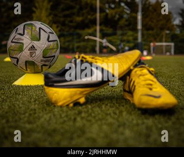 A pair of Nike Ctr360 Maestri Soccer shoes against the ball on the field at Wilson Playfields, Kent Stock Photo