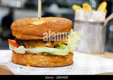 classic beef and cheese burger with butter croissant bun Stock Photo