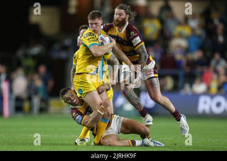 Leeds Rhinos' Morgan Gannon is tackled by Wigan Warriors' Sam Walters ...