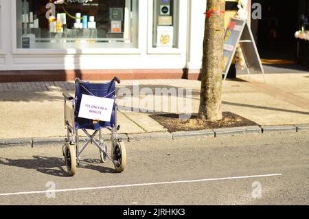 'Back in 5' campaign shows wheelchair in car parking space at protest of car drivers parking in disabled bays Stock Photo