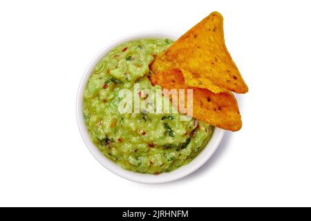 Bowl of guacamole with dipped nachos on white Stock Photo