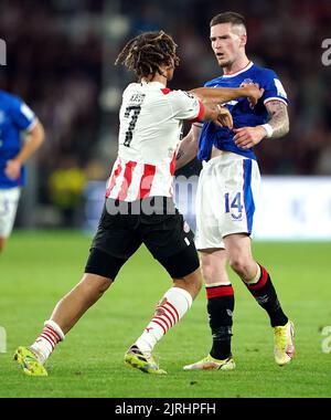 PSV Eindhoven's Xavi Simons (left) and Rangers' Ryan Kent clash during the UEFA Champions League qualifying match at PSV Stadion, Eindhoven. Picture date: Wednesday August 24, 2022. Stock Photo