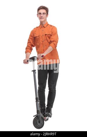 Pleasant smiling man riding a kick scooter Stock Photo