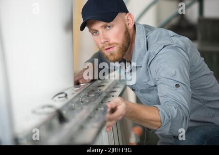 young man checking a ladder before Stock Photo