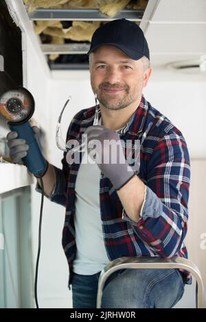 male contractor using angle grinder Stock Photo