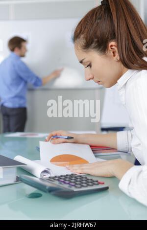 student girl with calculator in classroom Stock Photo
