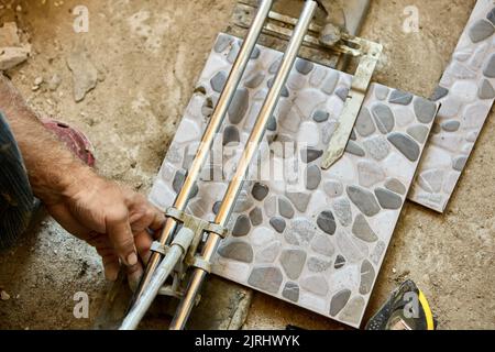 Tile cutter is used by tiler for interior construction work. Stock Photo