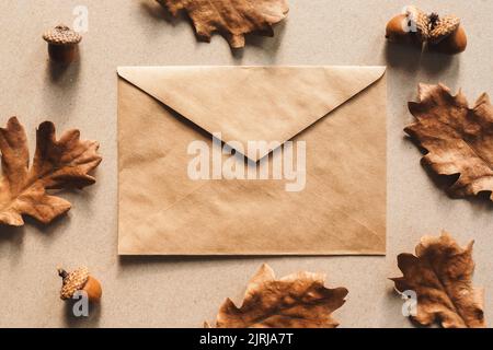 Autumn flat lay, fall background with kraft paper envelope and oak leaves Stock Photo