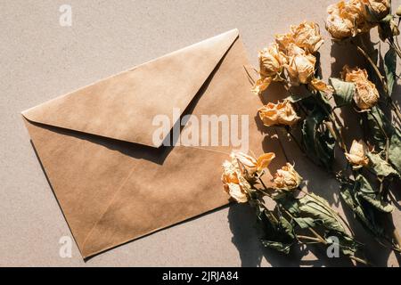 Dry flowers and brown paper envelope, vintage flat lay Stock Photo