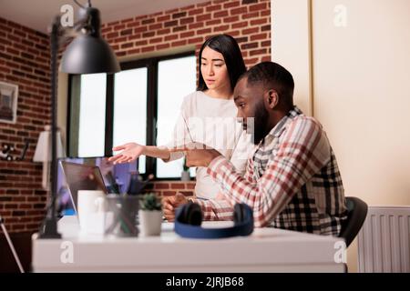 Software developers using coding terminal window on laptop, programming new online app interface with css html script. Developing encryption source with firewall and cloud computing. Stock Photo
