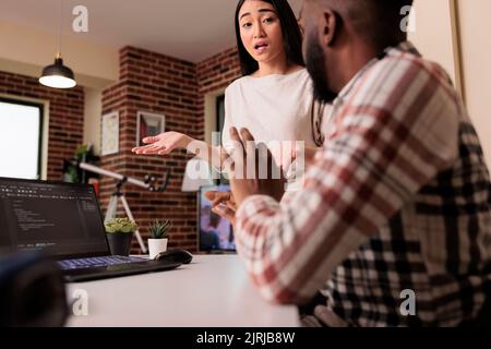Web developers using digital terminal window on laptop, programming new online app interface with css html script. Developing encryption source with firewall and cloud computing. Stock Photo