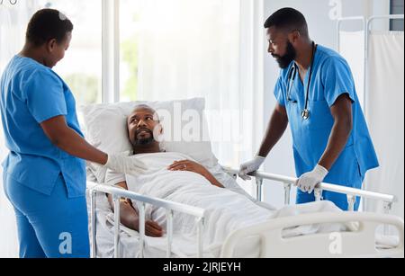 Doctor, nurse and healthcare team consulting man patient before a health check or surgery. Hospital or medical clinic help consulting about medicare Stock Photo