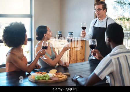 Wine tasting with friends and professional waiter explain the blend and flavor of red wine. Couple enjoying a drink, learning about wine making Stock Photo