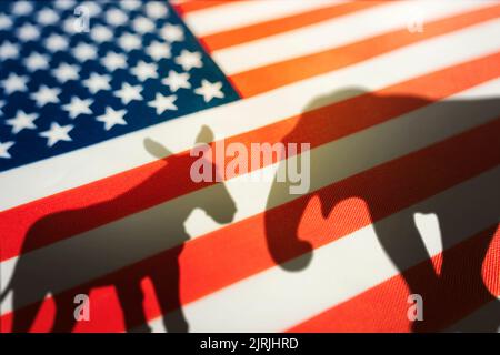 Democrats vs republicans are in a ideological duel on the american flag. In American politics US parties are represented by either the democrat donkey Stock Photo