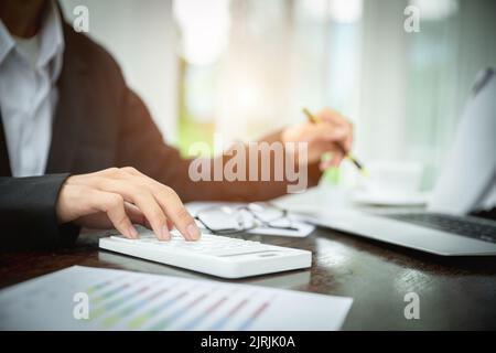 Young Businessman Analyzing Graph On Computer At Workplace Stock Photo