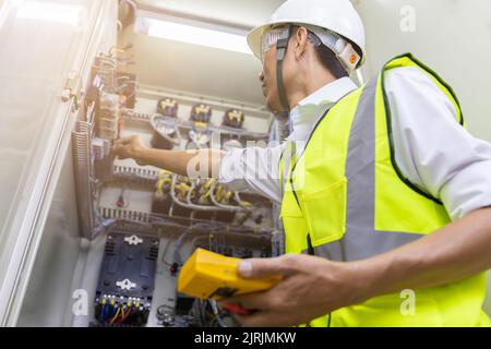 Male engineer checking electrical system with electronic equipment Stock Photo