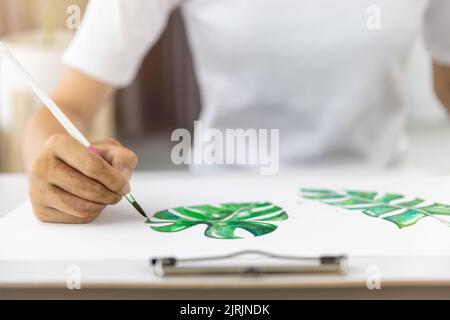 Close-up  Paint on a drawing board in the house to create art with watercolors and brushes. Stock Photo