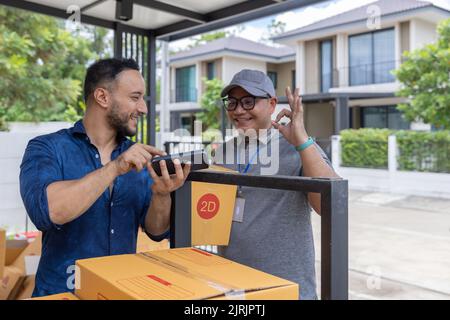 Two men check cardboard boxes, Carrying things into a new home. Stock Photo