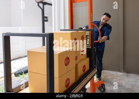 A man with carton boxes moving into new home. Stock Photo