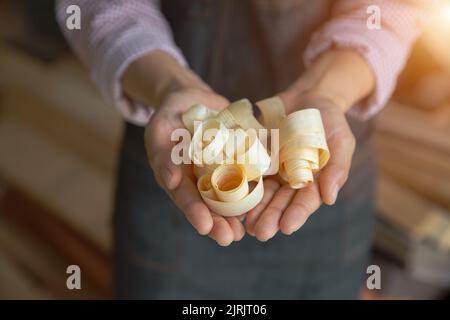 sawdust in the hands of a carpenter. Stock Photo