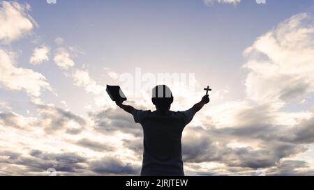 woman praying in the morning concept of christianity rising sun background Concept of prayer, faith, hope, love, liberation. Stock Photo