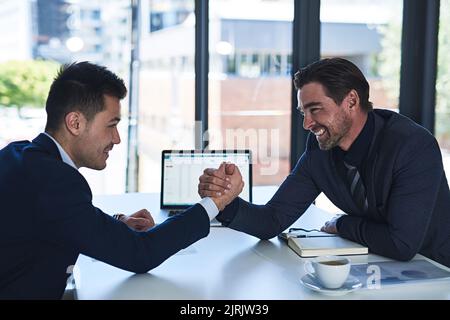 Let the games begin. two businessmen arm wrestling in an office. Stock Photo