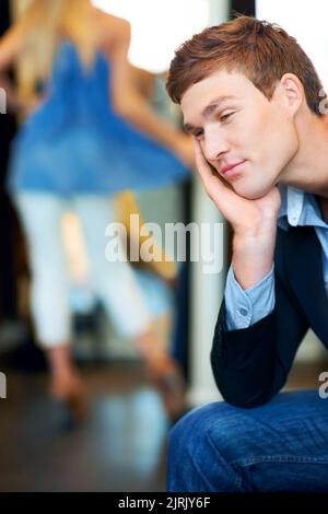 Fashion, retail and store with a tired man waiting for a woman while shopping in a clothing boutique. Patient person almost sleeping in a retail store Stock Photo