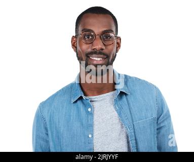 Cool and content. Cropped portrait of a young man standing against a white background. Stock Photo