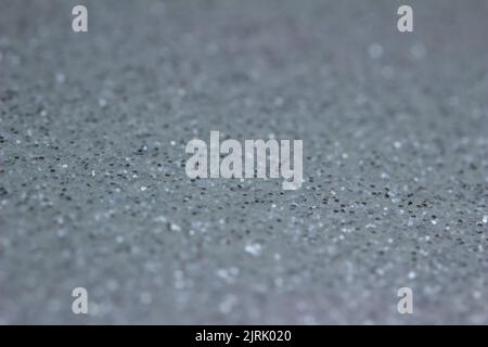 Full frame abstract texture of shimmering silver glitter background with selective focus Stock Photo