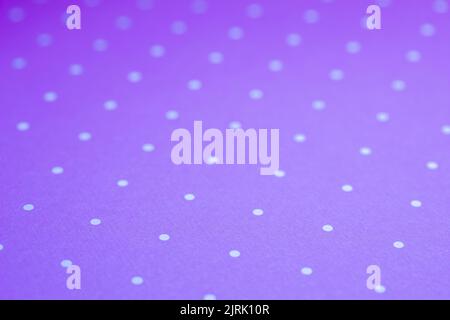 Full frame abstract texture background of solid purple and white polka dots pattern with selective focus Stock Photo
