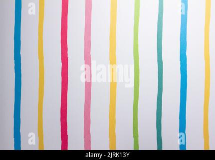 Full frame abstract texture of uneven primary color parallel striped lines on white paper background Stock Photo