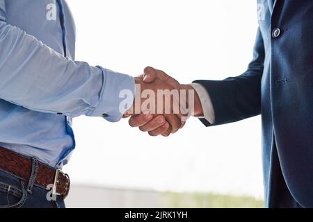 Theyve reached an agreement. Closeup shot of two businessmen shaking hands in an office. Stock Photo