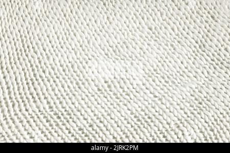 Sweater made of white wool in soft style. White texture of light knitted warm fabric. Stock Photo