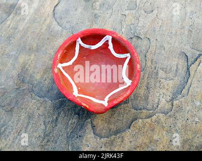 Close up of heap of Indian clay oil lanterns or diyas for Diwali festival celebration at local market stall textured backgrou Stock Photo