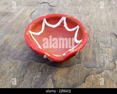 Close up of heap of Indian clay oil lanterns or diyas for Diwali festival celebration at local market stall textured backgrou Stock Photo