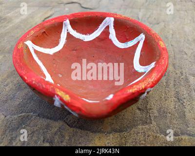 Close up of heap of Indian clay oil lanterns or diyas for Diwali festival celebration at local market stall textured backgrou Stock Photo