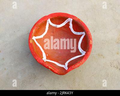 Close up of heap of Indian clay oil lanterns or diyas for Diwali festival celebration at local market stall textured backgrou Stock Photo