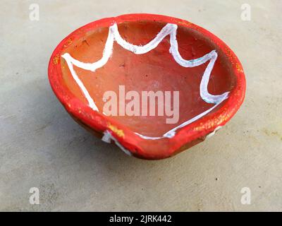 Close up of heap of Indian clay oil lanterns or diyas for Diwali festival celebration at local market stall textured backgrou Stock Photo