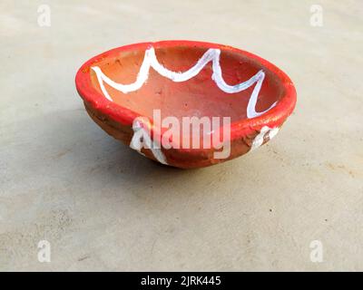 Close up of heap of Indian clay oil lanterns or diyas for Diwali festival celebration at local market stall textured backgrou Stock Photo