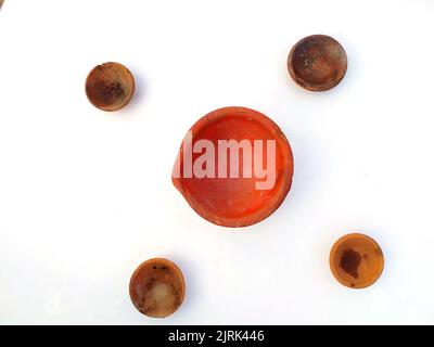 Close up of heap of Indian clay oil lanterns or diyas for Diwali festival celebration at local market stall textured backgrou Stock Photo